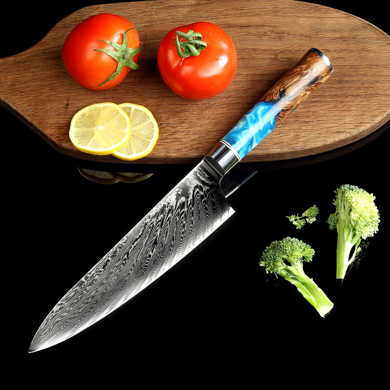 Pattern kitchen knife with a blue and wood handle on black background beside tomatoes lemon slices and broccoli