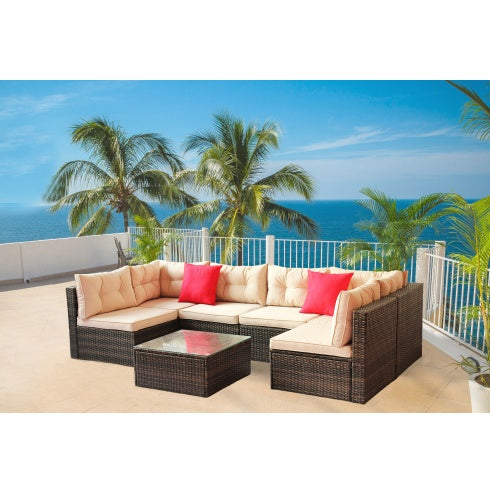 PE rattan garden corner furniture set with beige cushions and red pillows on ocean-view patio
