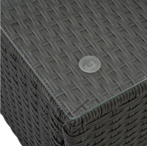 Close-up of black PE rattan patio furniture with glass tabletop and woven texture