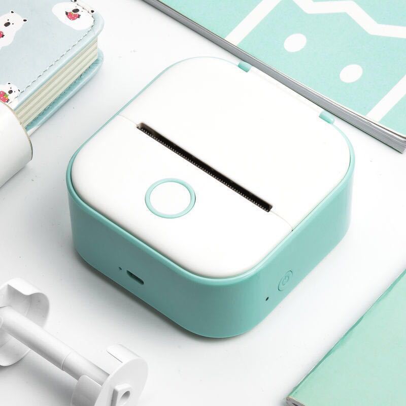 Shopi Vella portable mini thermal label printer in white and teal for on-the-go label printing