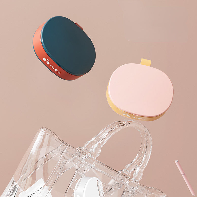 Shopi Vella portable weekly pill organizer in blue and pink with compact design for easy storage