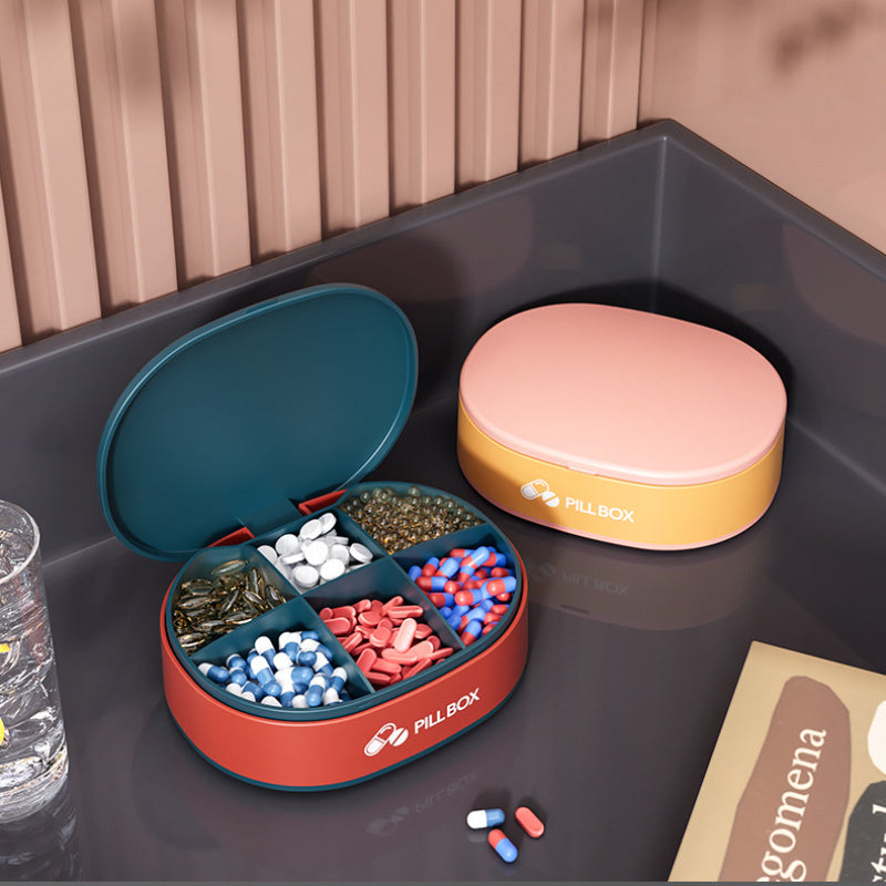 Shopi Vella portable weekly pill organizer with six compartments filled with various pills and capsules