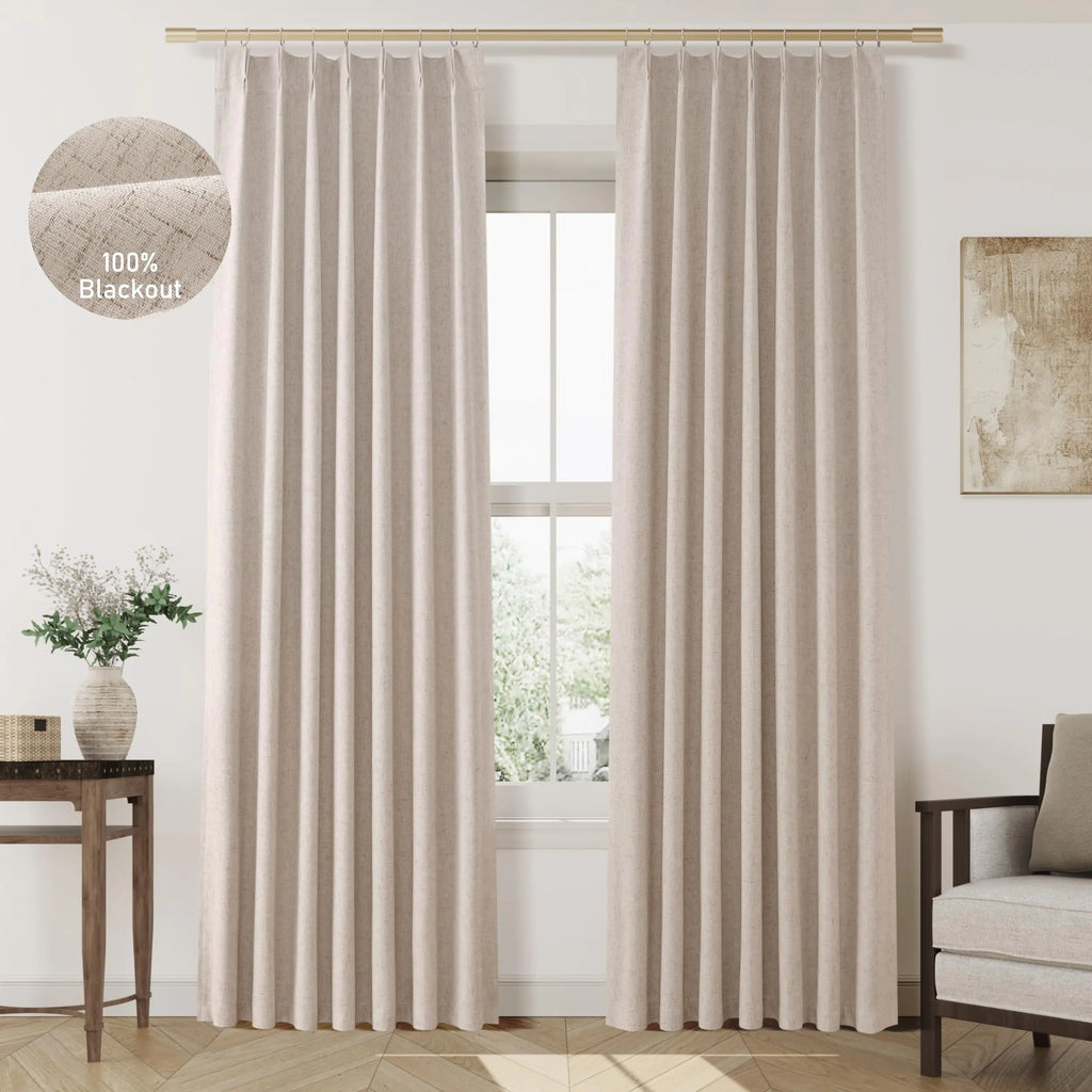Beige 100% blackout pinch pleat curtains 84 inch hanging in a modern living room