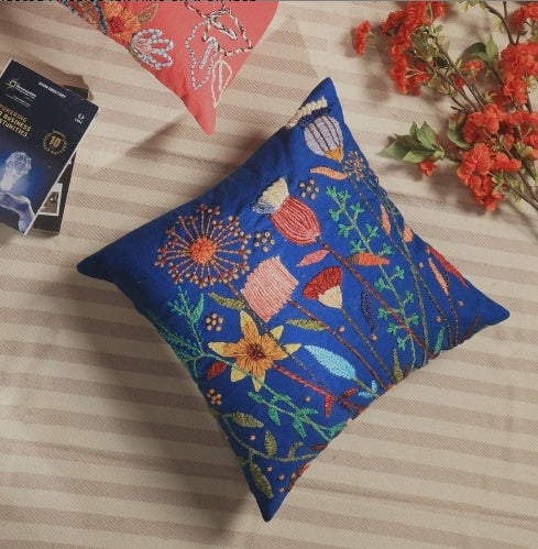 Shopi Vella pink embroidered cushion cover with floral design on blue pillow case