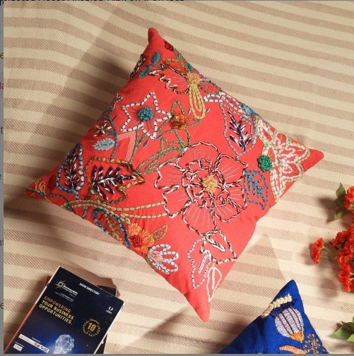 Shopi Vella pink embroidered cushion cover with colorful floral designs on a striped fabric background