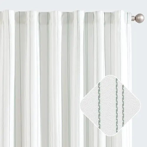 White pinstripe privacy light filtering curtains hanging on silver curtain rod with close-up of fabric texture