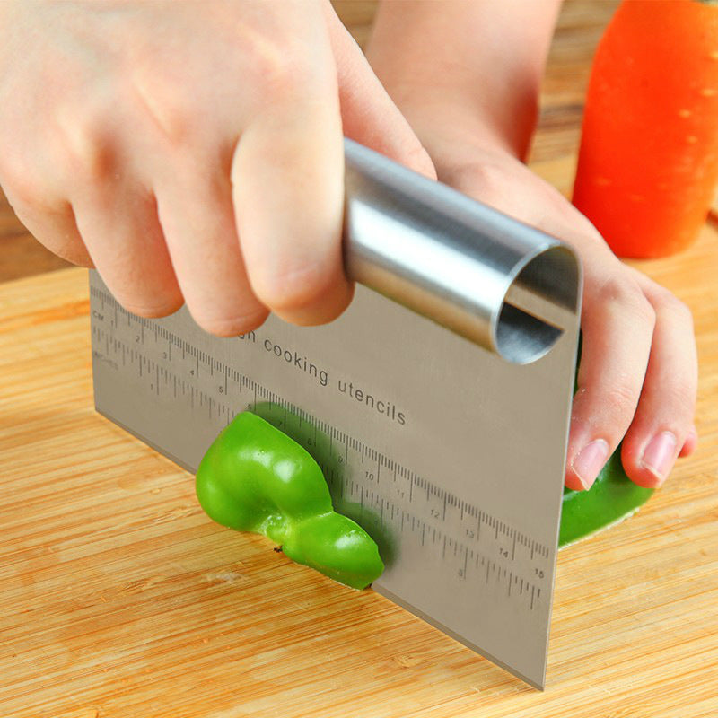 Shopi Vella pizza dough cutter tool slicing green bell pepper on wooden cutting board
