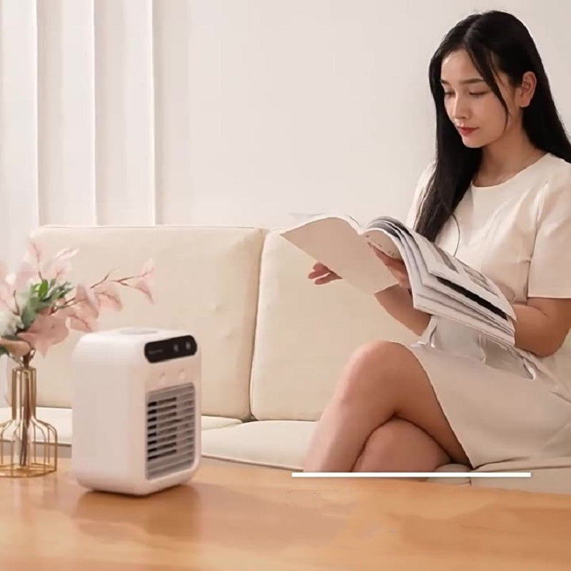 Shopi Vella portable air cooler for room on table with woman reading magazine on couch