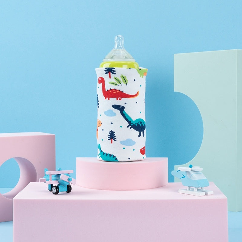 Shopi Vella portable baby bottle warmer with colorful dinosaur print on pink display stand