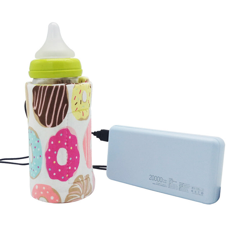 Shopi Vella portable baby bottle warmer with donut print connected to a power bank for on-the-go use