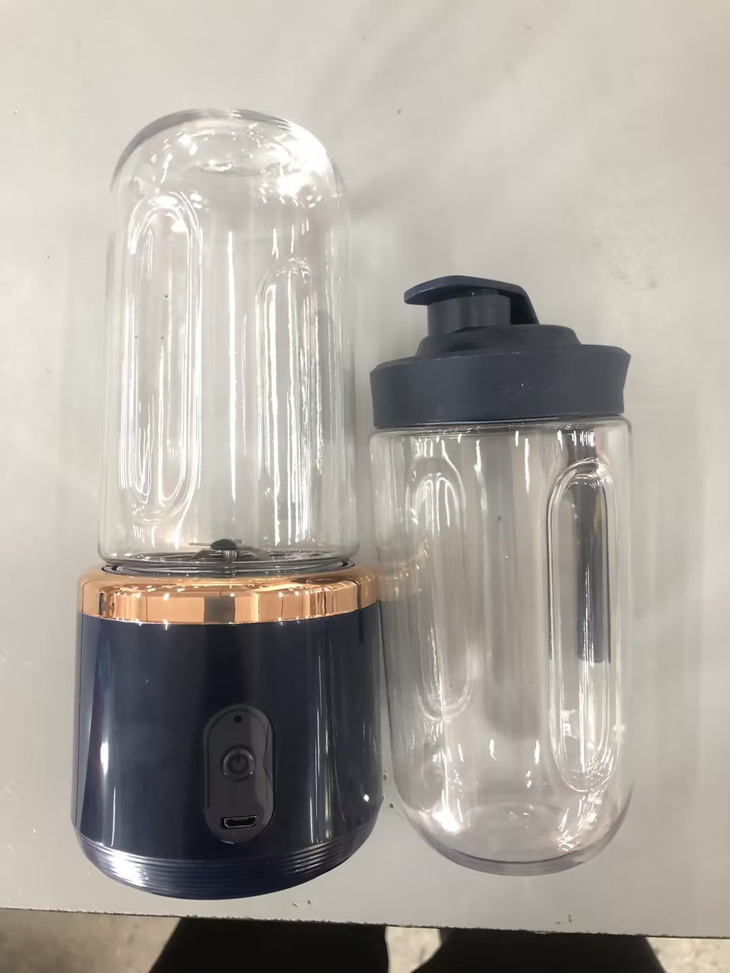 Shopi Vella portable blender for smoothies with navy base and two clear blending jars