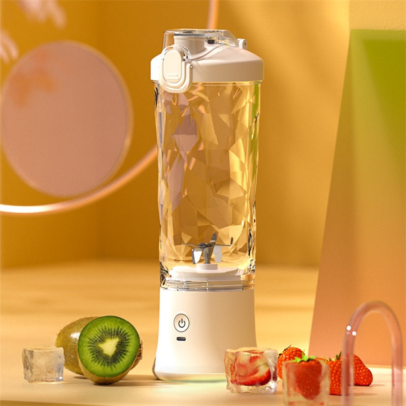 Shopi Vella portable blender for smoothies with clear container and white base surrounded by fruits