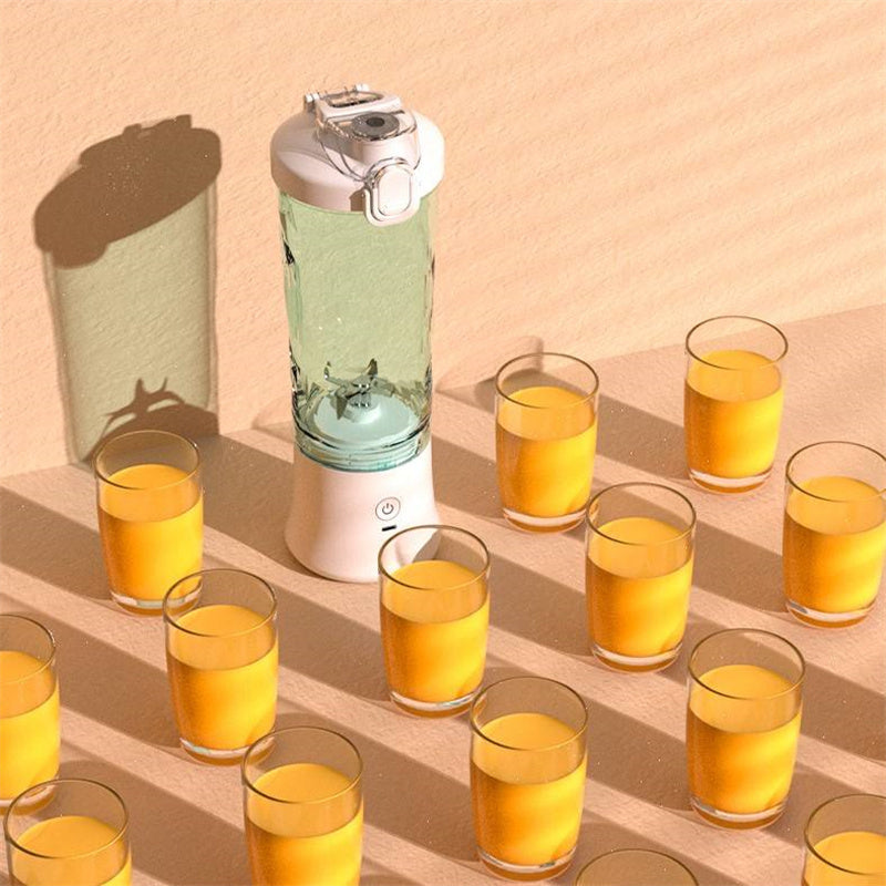 Shopi Vella portable blender for smoothies with multiple glasses of orange juice on a beige surface