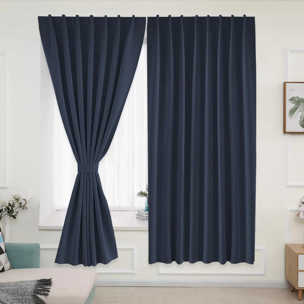 Dark blue portable curtains for rental homes neatly hung in a bright living room window