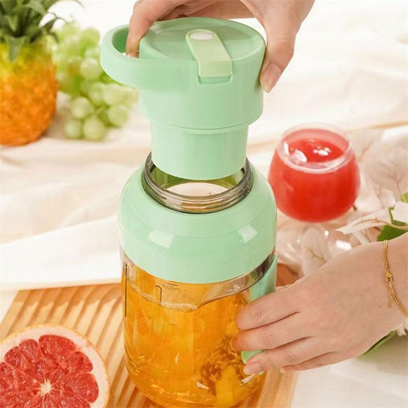 Shopi Vella portable electric juicer blender in green being used to blend fresh fruit juice