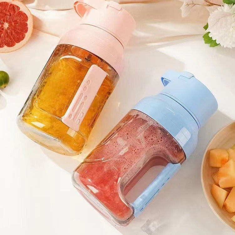 Shopi Vella portable electric juicer blender in pink and blue with fresh fruit smoothies inside