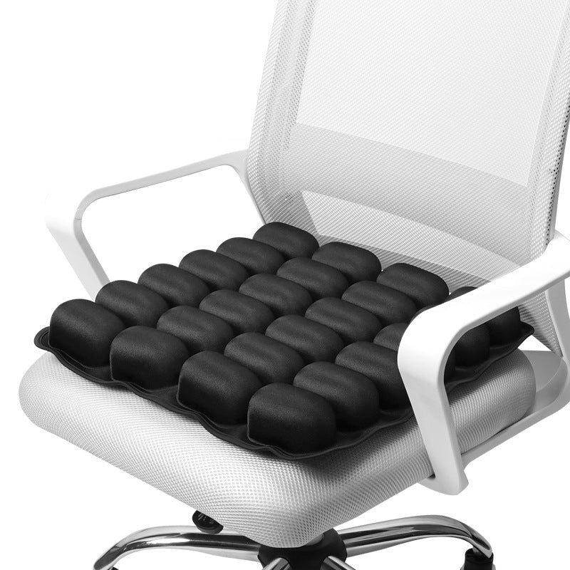 Shopi Vella portable inflatable seat cushion in black placed on white office chair for comfort