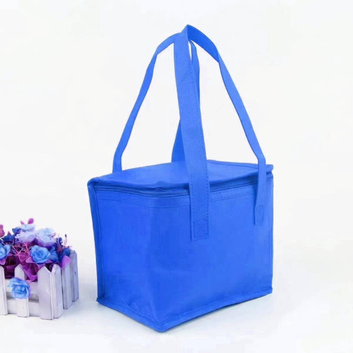 Blue portable insulated lunch bag with long handles for easy carrying by Shopi Vella