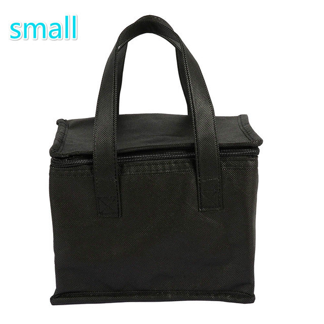 Small black portable insulated lunch bag by Shopi Vella with sturdy handles and zipper closure
