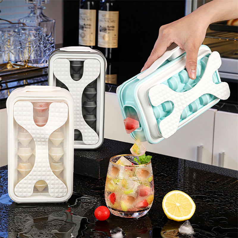 Shopi Vella portable silicone ice ball mold in white and teal being used to make round ice cubes for drinks