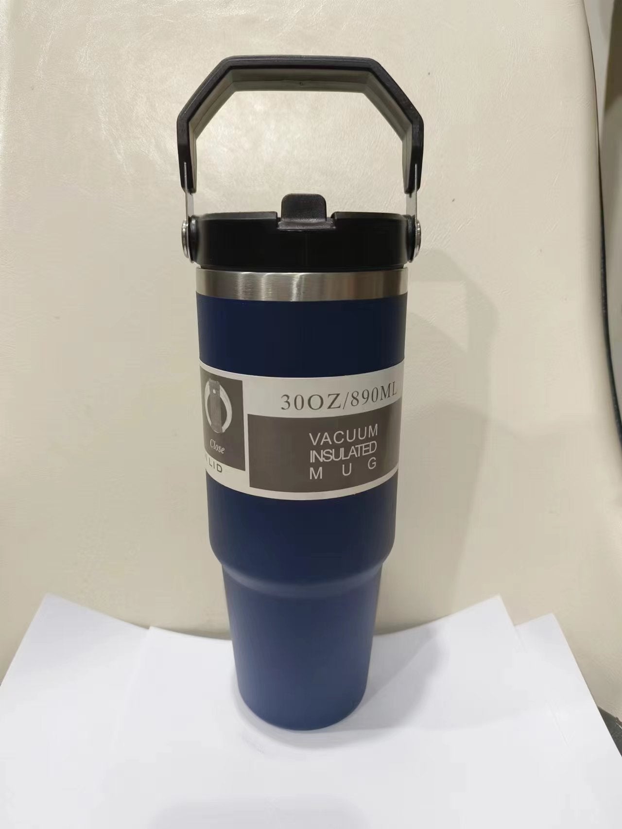 Shopi Vella portable stainless steel travel mug in blue with vacuum insulated 30oz capacity and black handle