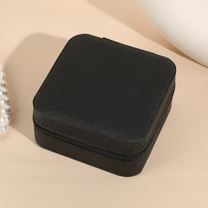 Shopi Vella black portable travel jewelry box with zippered closure for secure storage