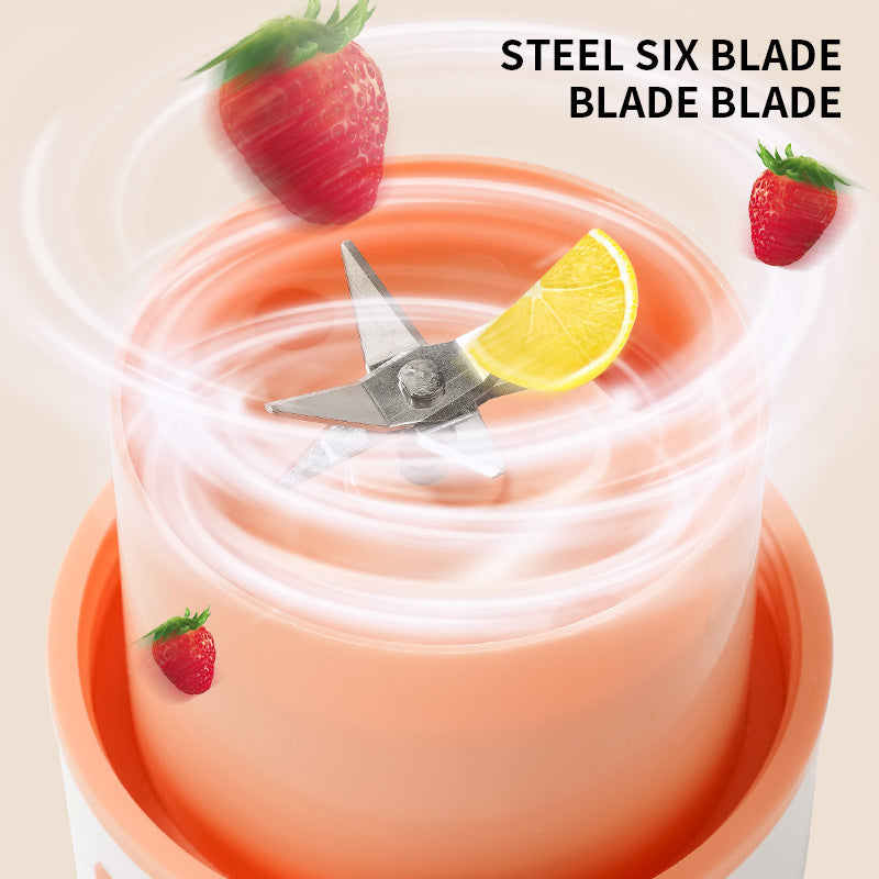 Wireless portable juicer cup with steel six blade blending strawberries and lemon slice