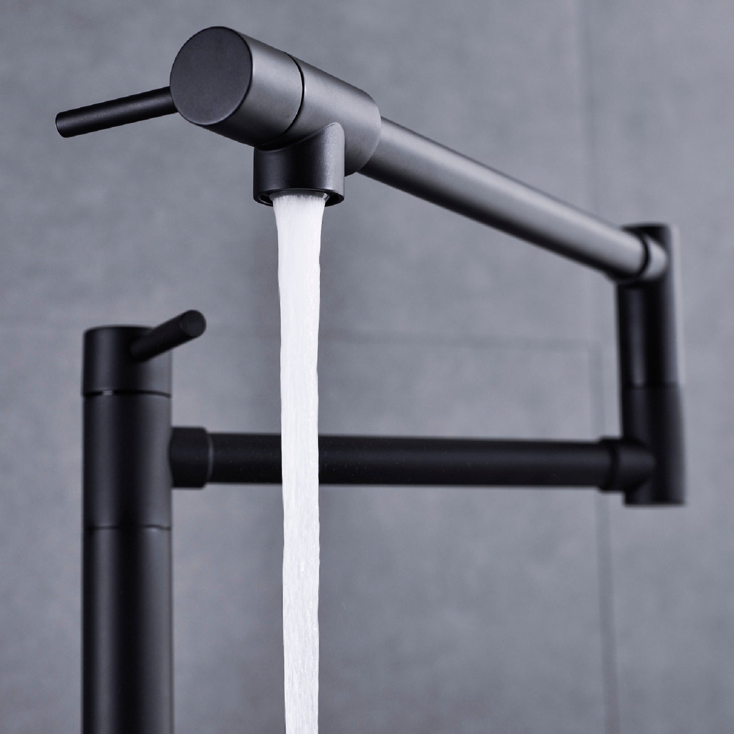 Shopi Vella black pot filler faucet with extended handle mounted on a gray tiled wall