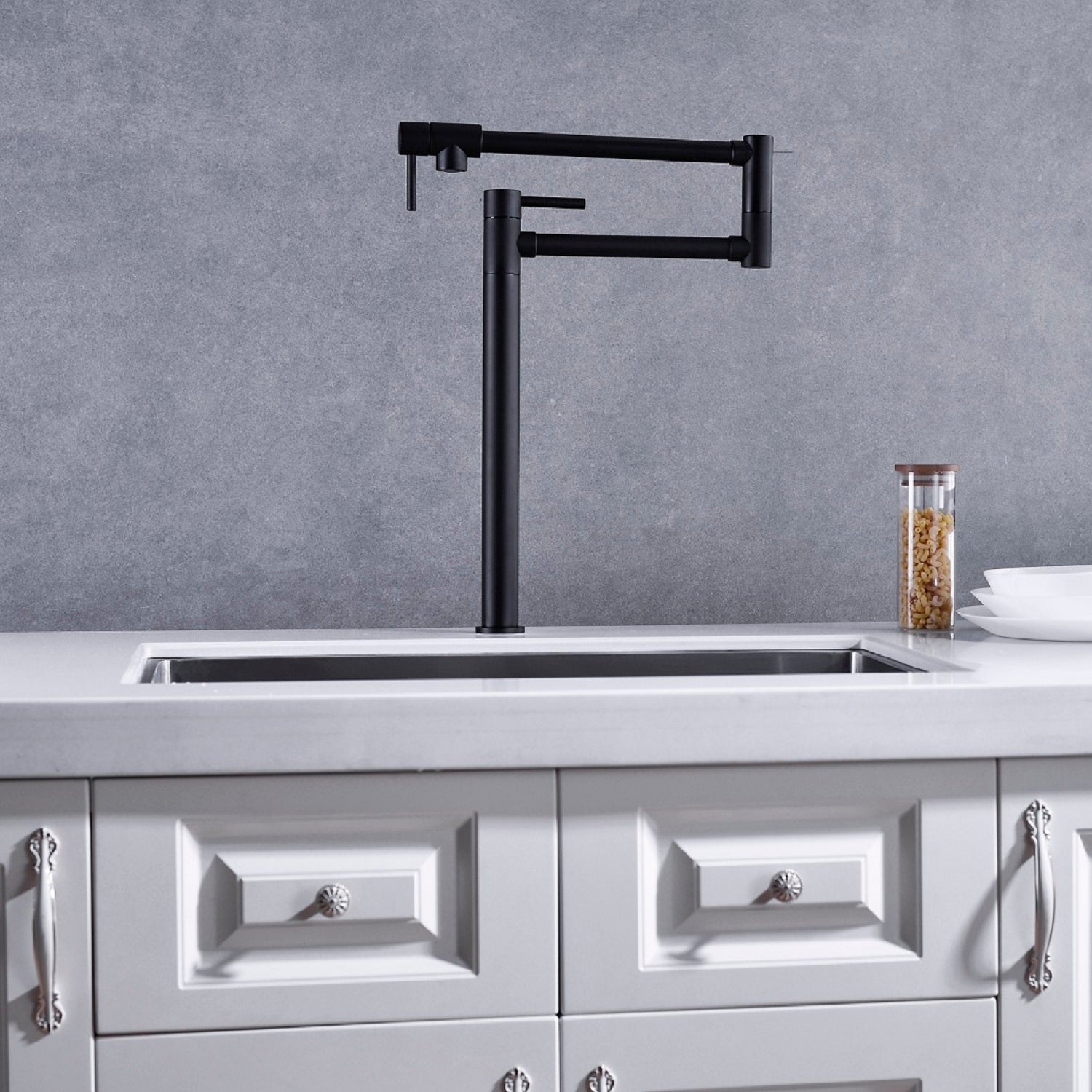Shopi Vella black pot filler faucet with extended handle installed above kitchen sink with gray backsplash