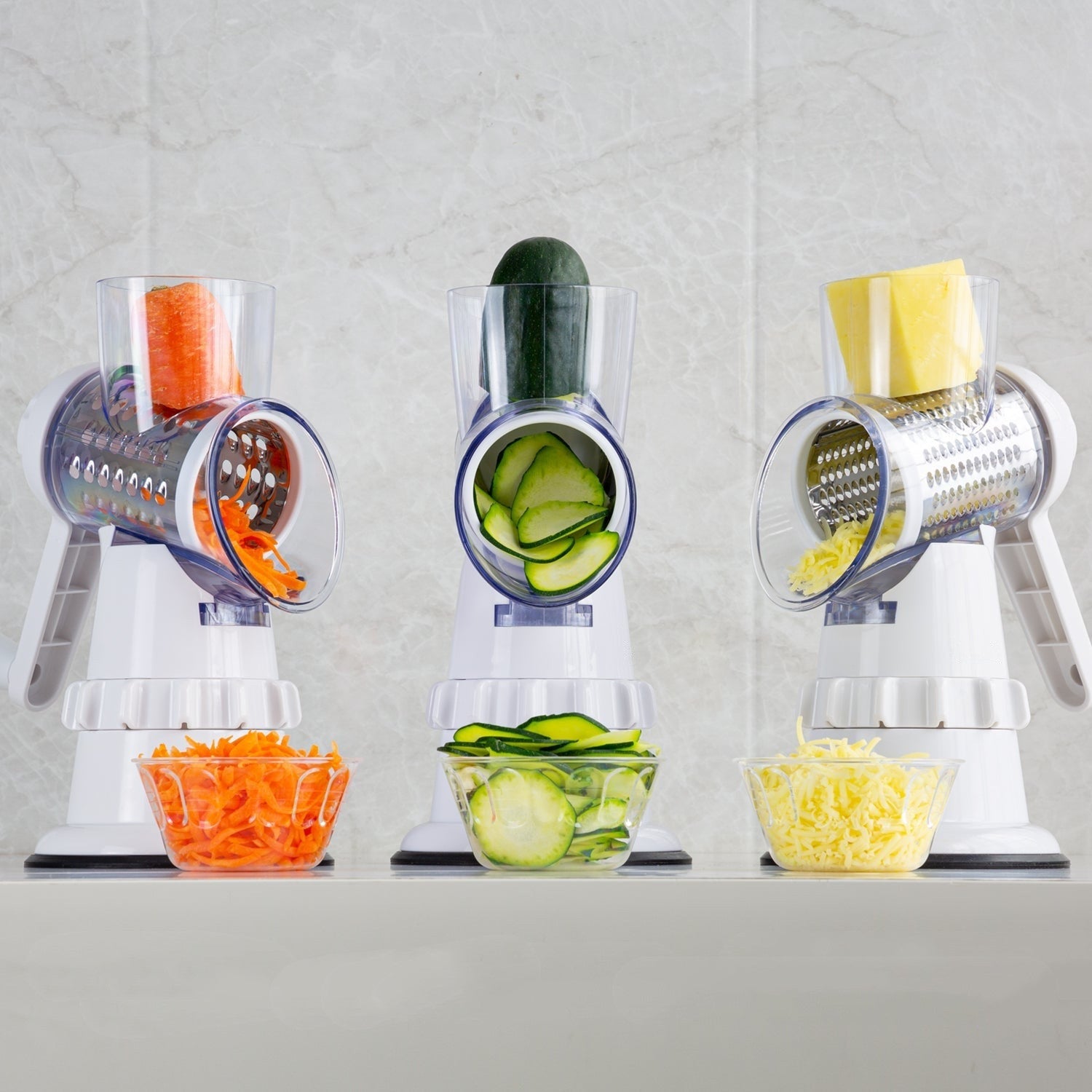 Shopi Vella potato and vegetable round shredder grating carrots cucumbers and potatoes into bowls