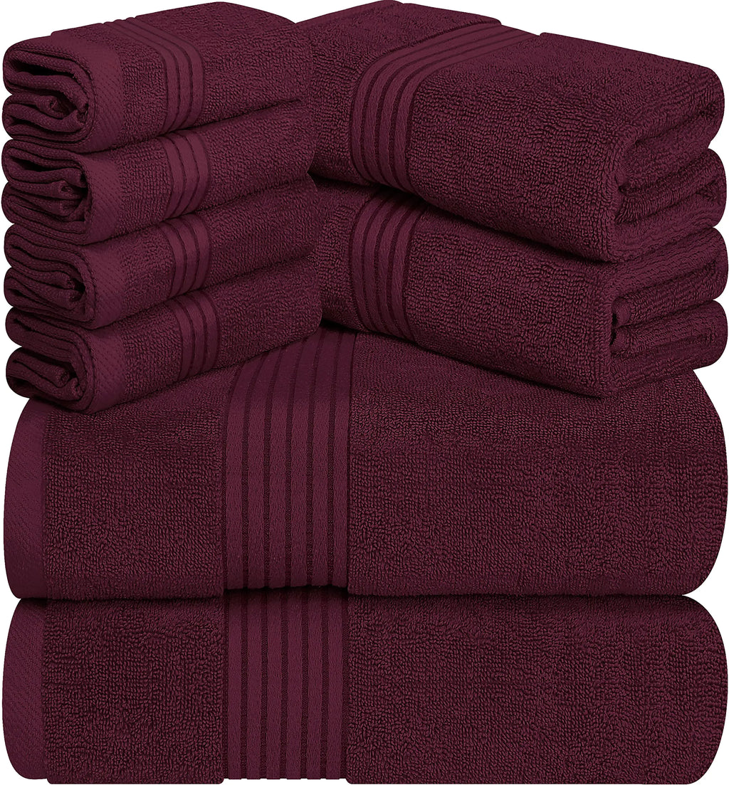 Set of premium burgundy towel set with multiple plush towels neatly stacked for bath and hand use