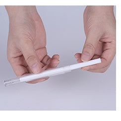 Shopi Vella projection night light humidifier for bedroom slim white design being held in hands
