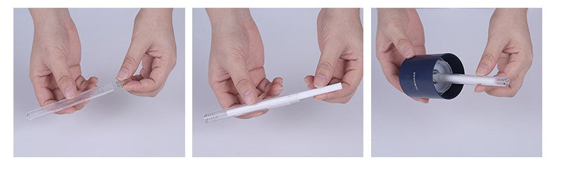 Hands assembling a projection night light humidifier for bedroom showing clear tube and dark blue base components