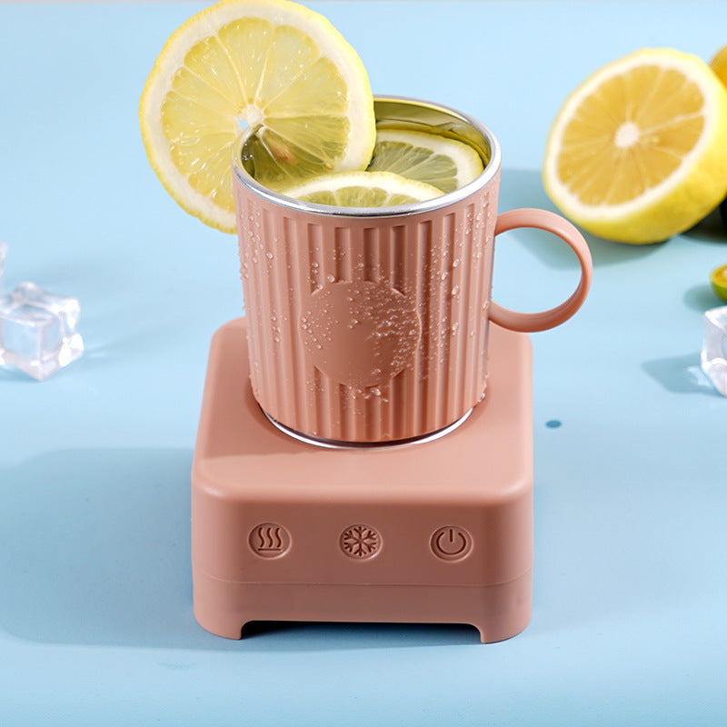 Shopi Vella quick beverage ice maker machine with pink cup holding lemon slices on blue surface