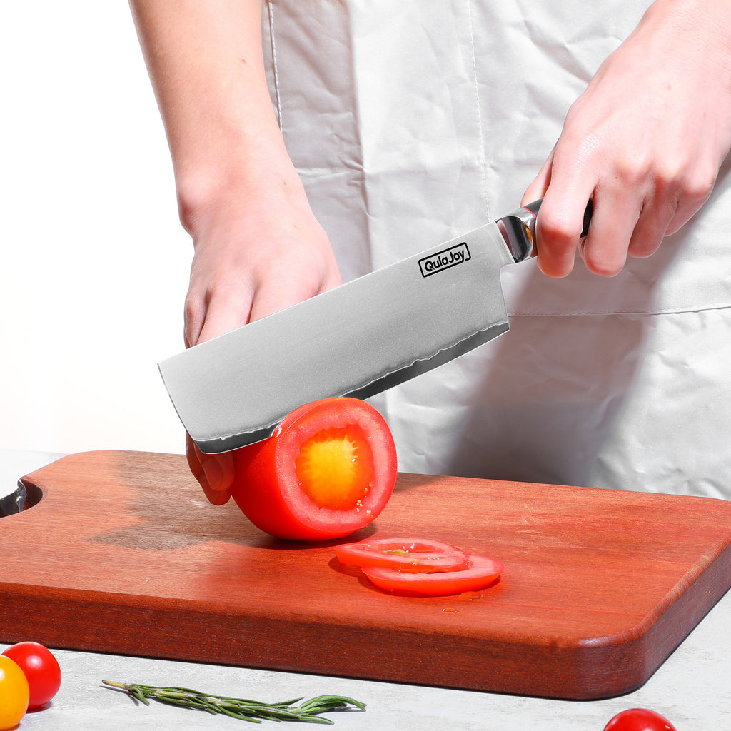 Shopi Vella 10Cr15MoV steel slicing knife slicing a tomato on a wooden cutting board