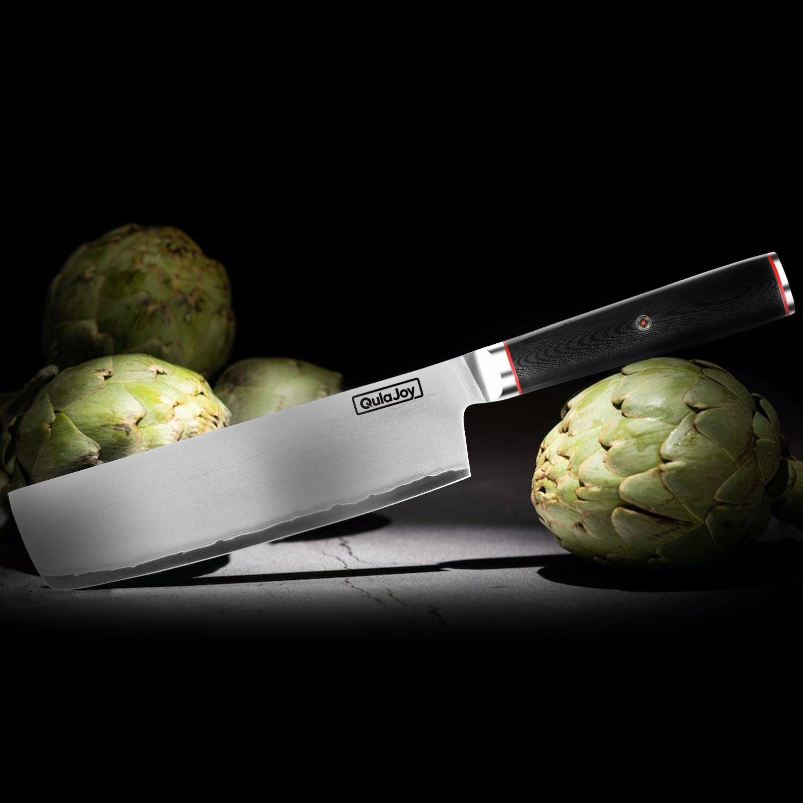 Shopi Vella 10Cr15MoV steel slicing knife with black handle beside fresh artichokes