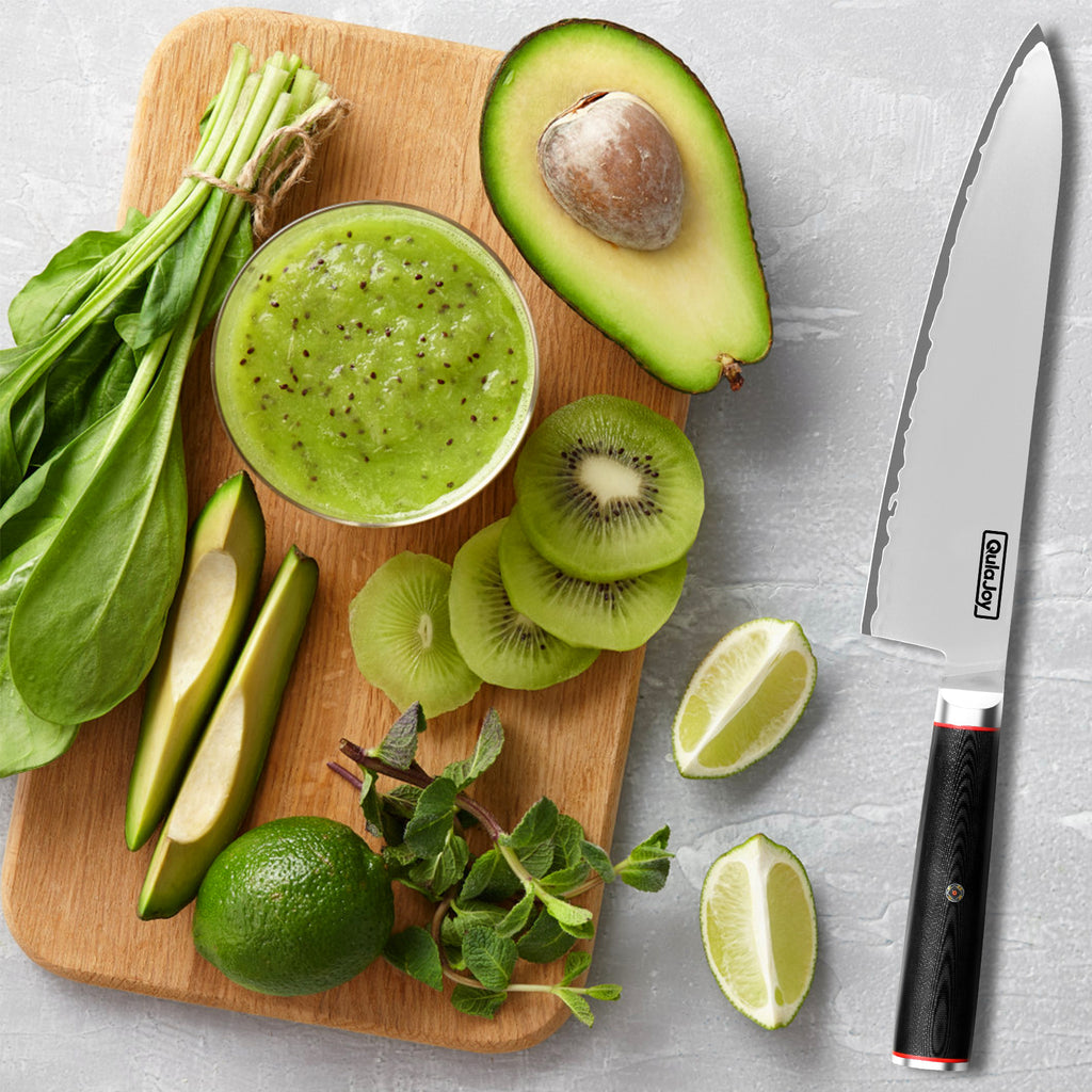 10Cr15MoV steel slicing knife with black handle next to cutting board with avocado, kiwi, lime, spinach, and green smoothie