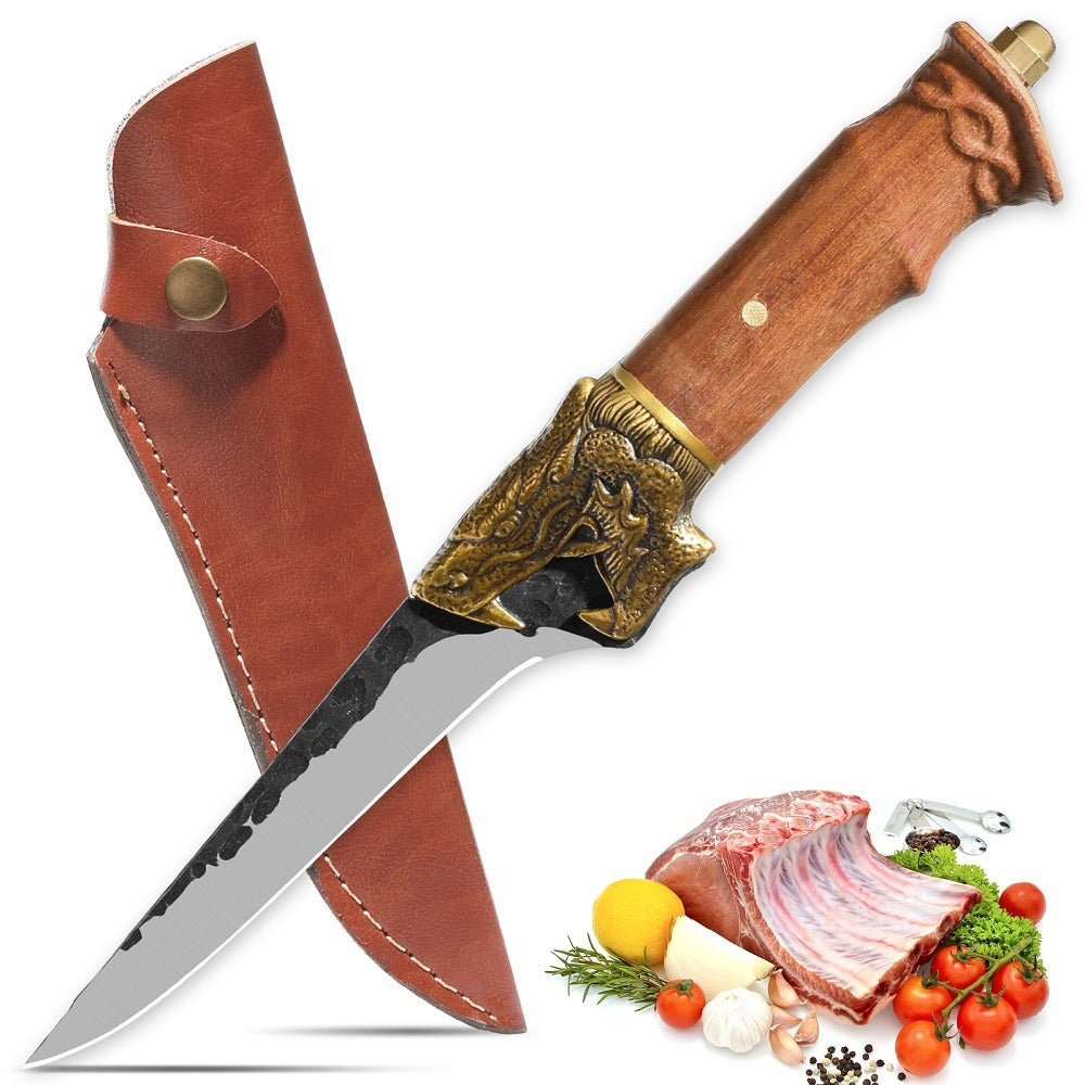 Shopi Vella dragon head camping knife with wooden handle and leather sheath next to fresh meat and vegetables