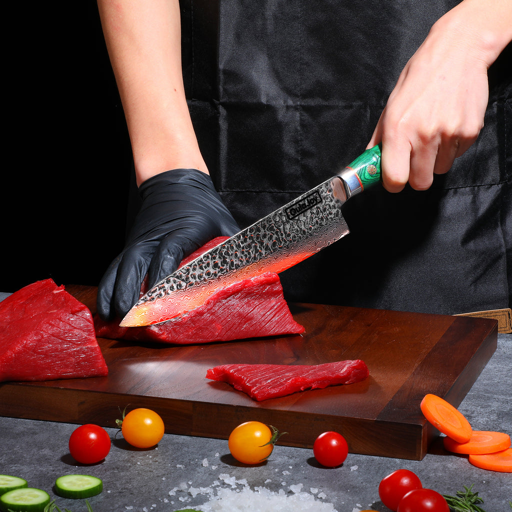 Hand using handcrafted Japanese knife bamboo handle to slice fresh red meat on wooden cutting board