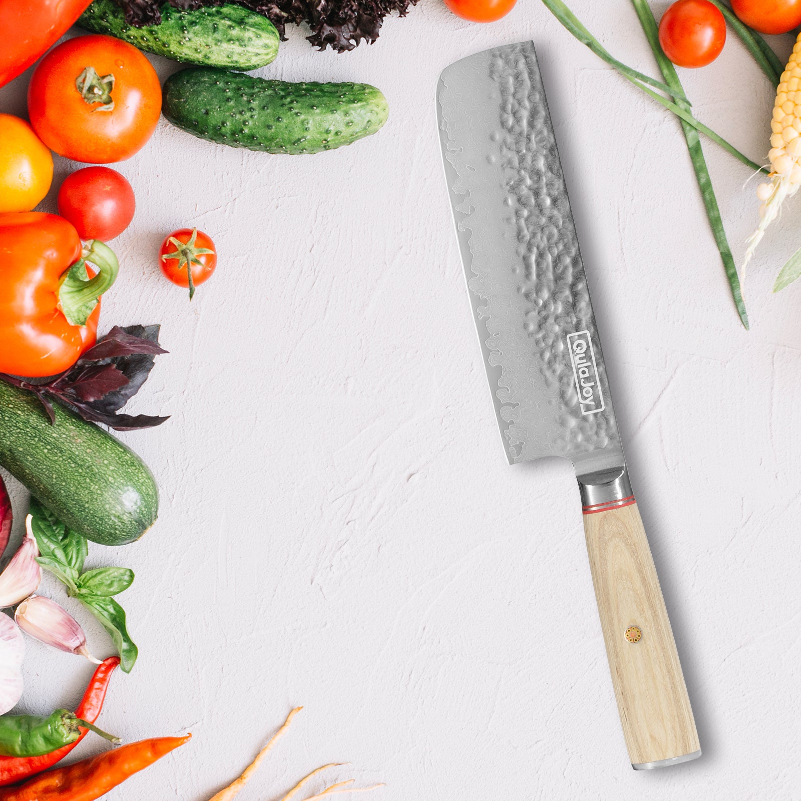 Nakiri knife Japanese vegetable with wooden handle surrounded by fresh vegetables on white surface