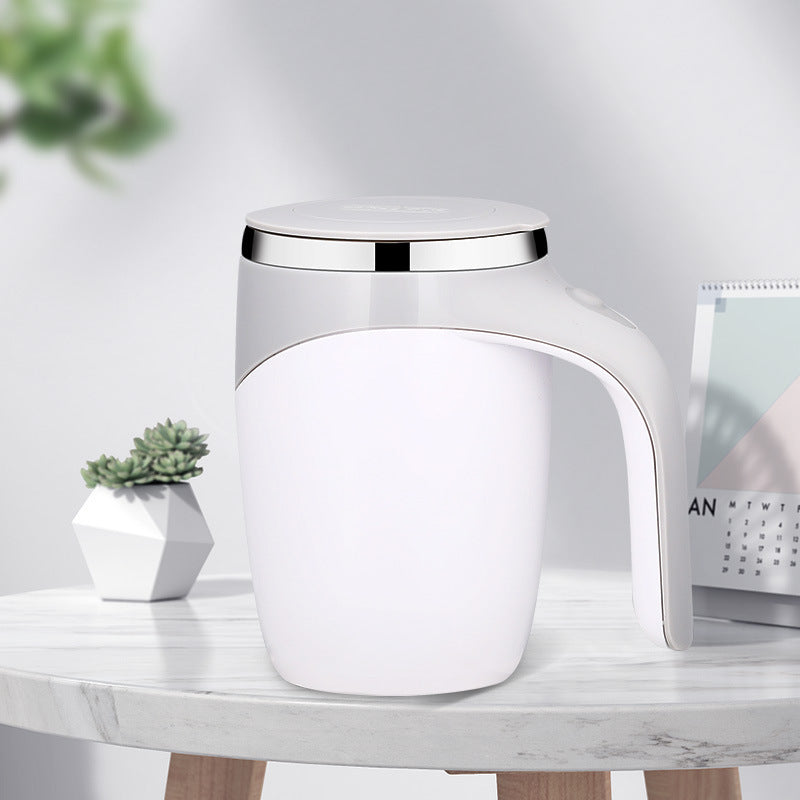 Shopi Vella rechargeable automatic stirring cup in white with silver rim on a marble table