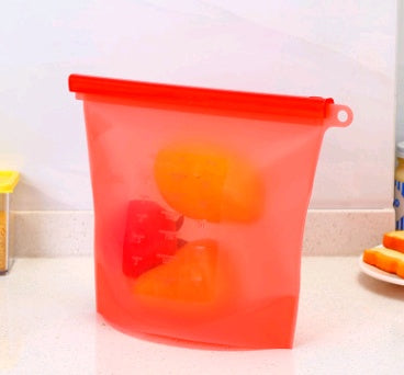 Shopi Vella red silicone food storage bag containing cut bell peppers on kitchen counter