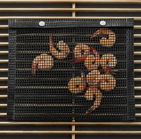 Shopi Vella reusable BBQ grill mesh bag with cooked shrimp on a grill for easy grilling and cleanup