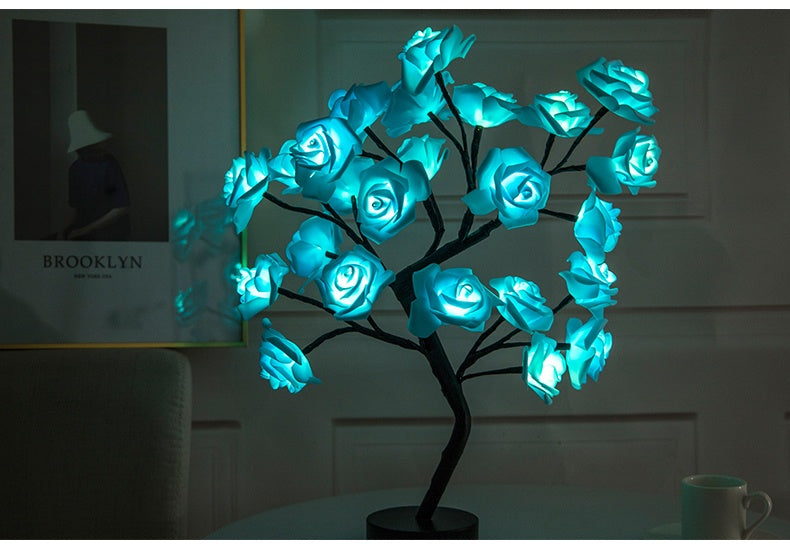 Shopi Vella rose flower LED night lamp with glowing blue rose-shaped lights on a black base
