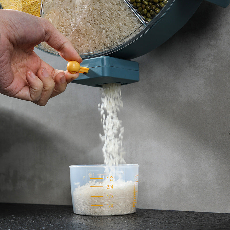 Shopi Vella rotating cereal dispenser for kitchen dispensing rice into a measuring cup on countertop