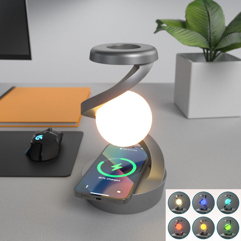 Shopi Vella rotating moon desk lamp with wireless charging on desk beside mouse and plant