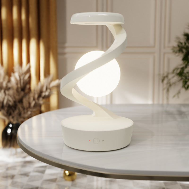 Shopi Vella rotating moon desk lamp with wireless charging on white marble table in living room