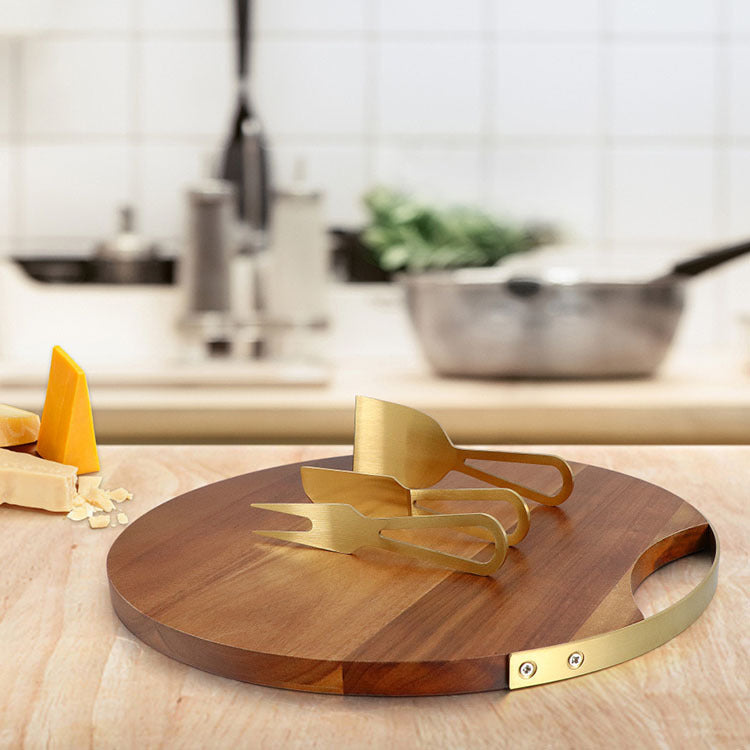 Shopi Vella cheese board and knife set with wooden round board and gold cheese knives on kitchen counter