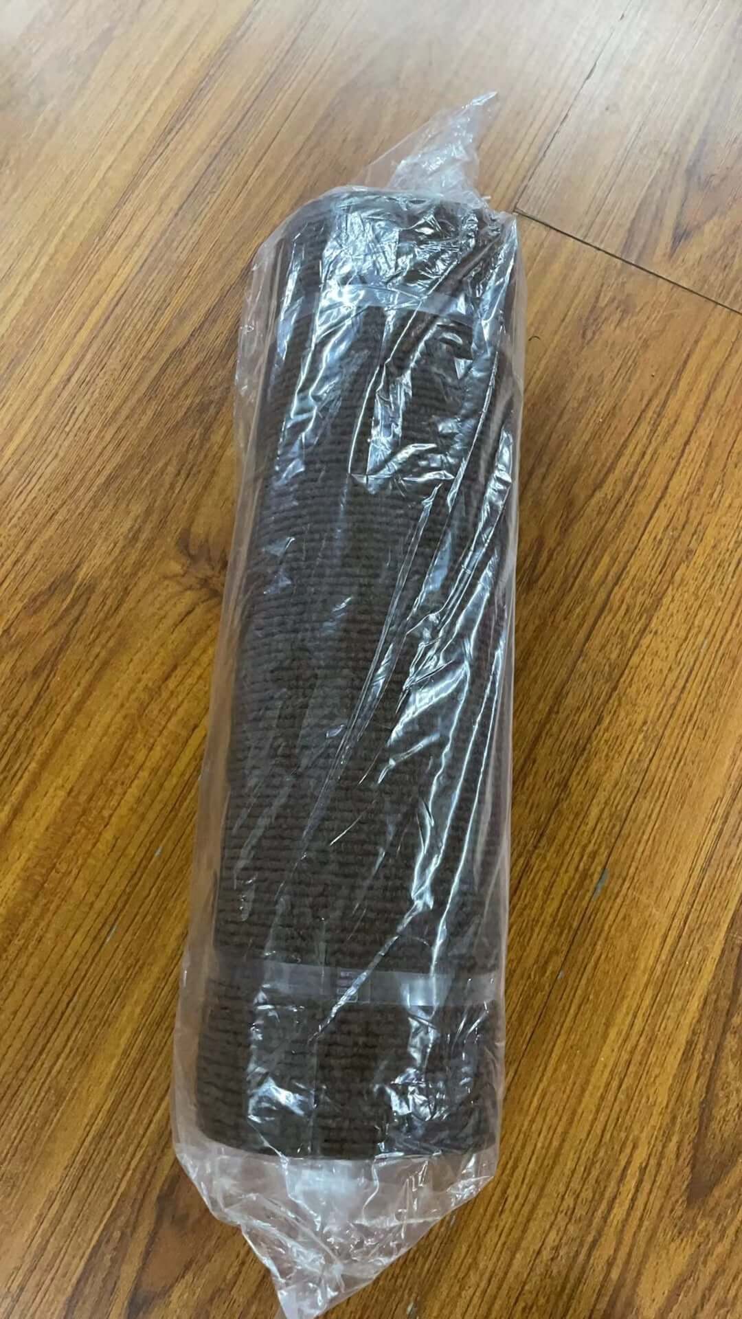 Shopi Vella self-adhesive cat scratch board rolled and wrapped in clear plastic on wooden floor