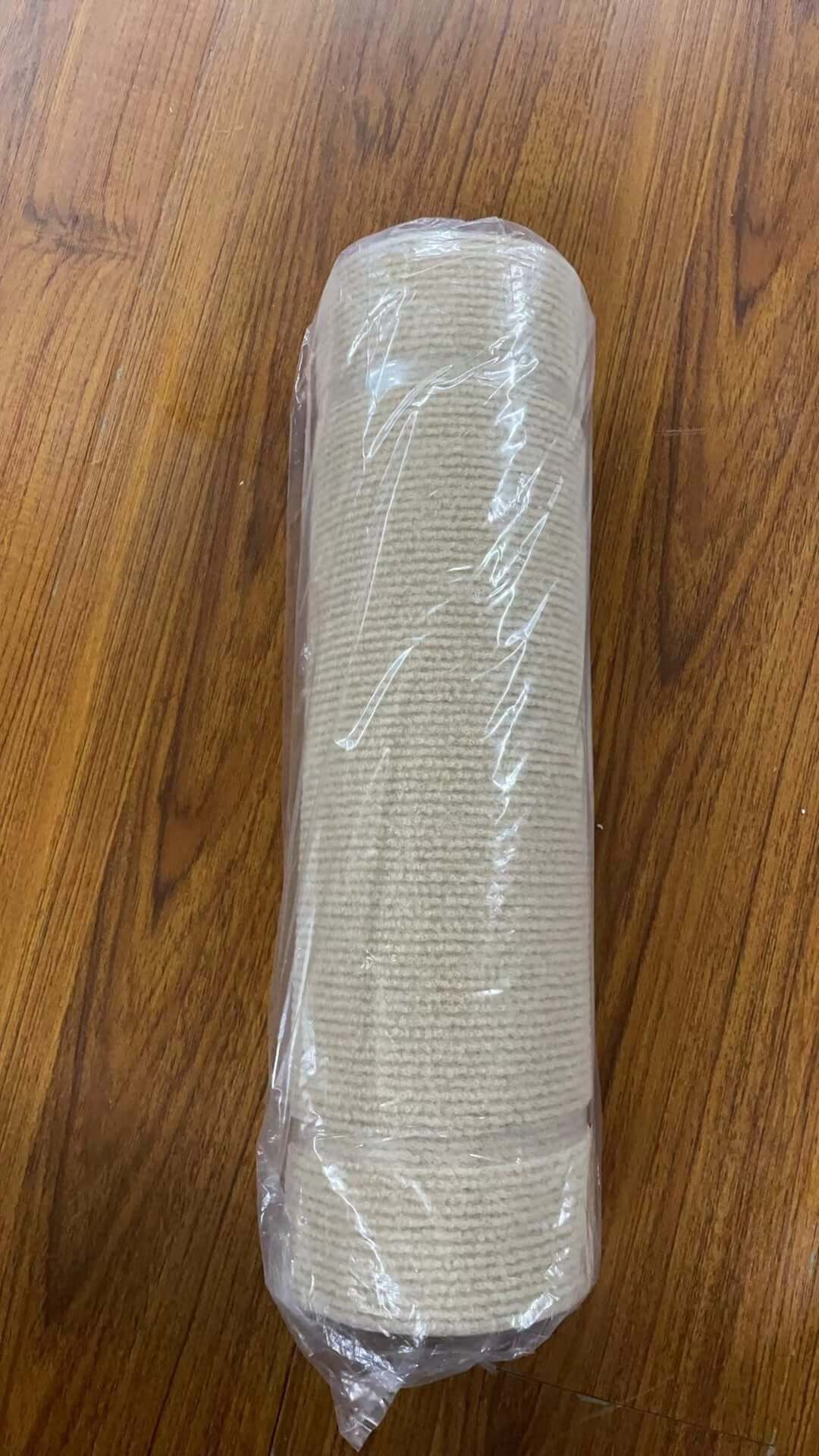 Shopi Vella self-adhesive cat scratch board rolled and wrapped in plastic on wooden floor